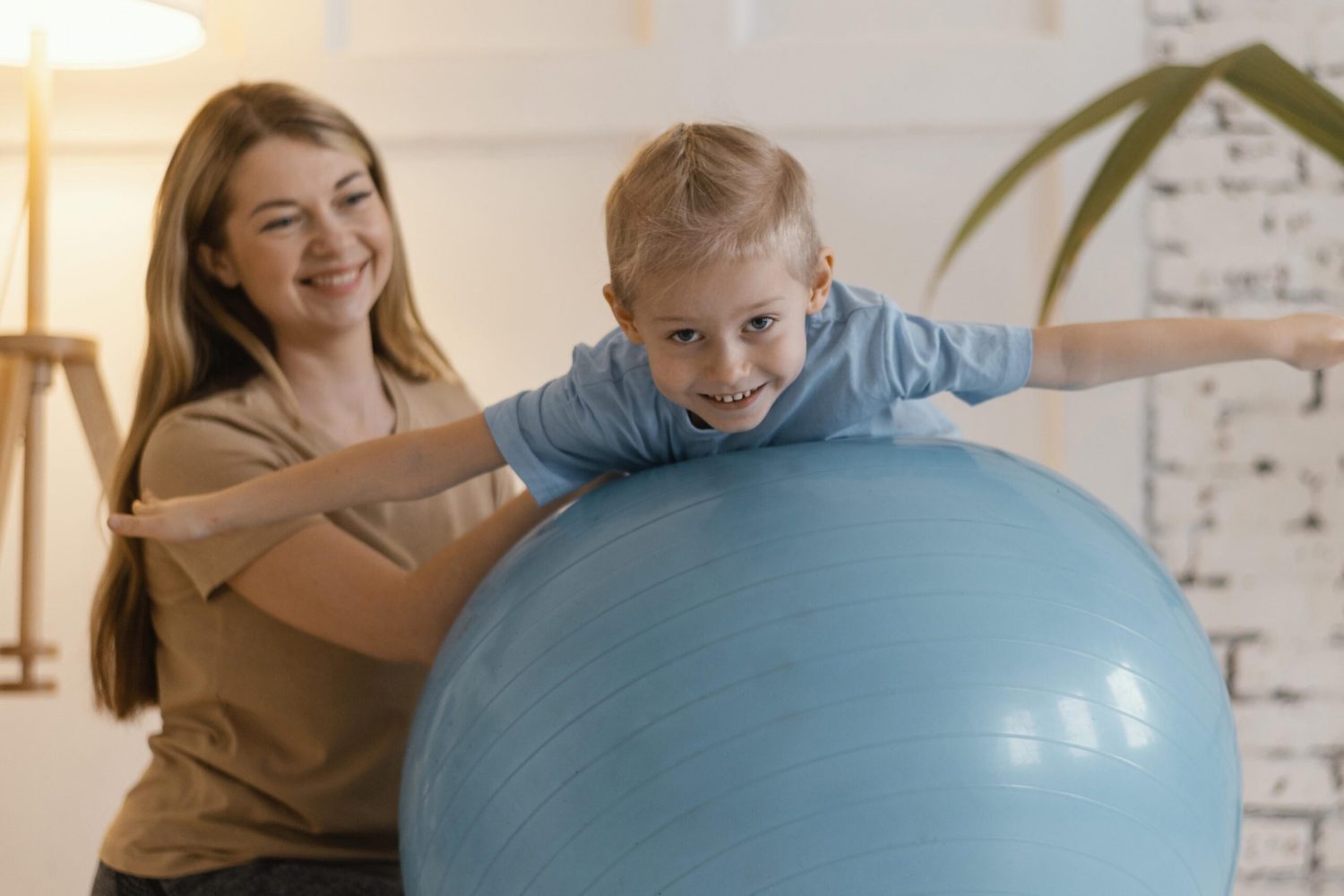 full-shot-kid-gym-ball-exercising-scaled